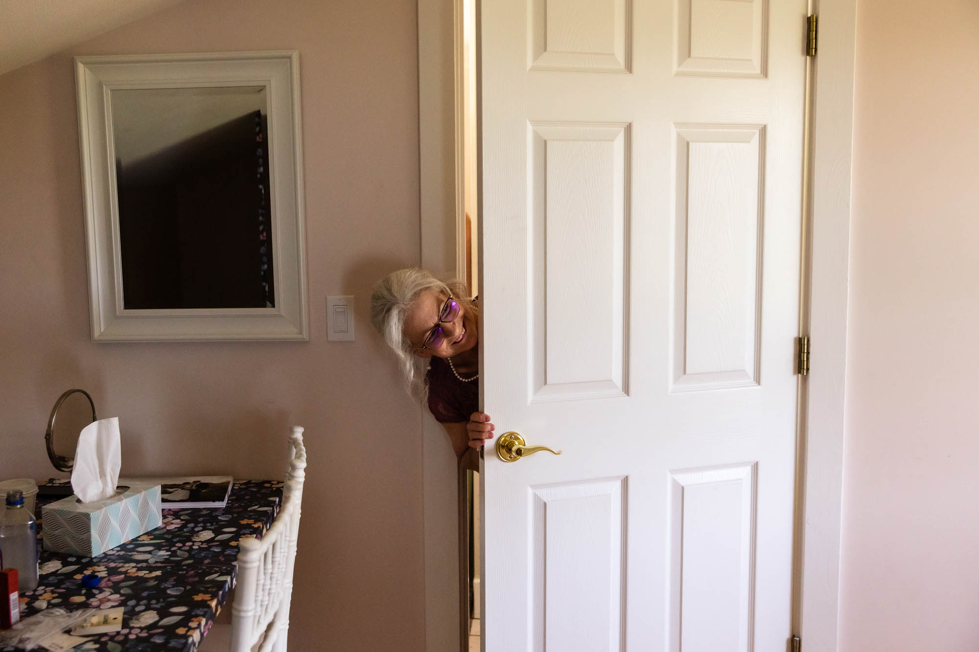 mother of the bride peeks in to see if the bride is ready for her wedding at pinehall at eisler farms